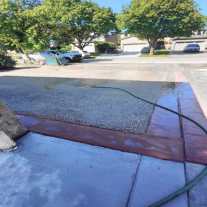 Exposed aggregate concrete porch with multi-tonal stone finish.