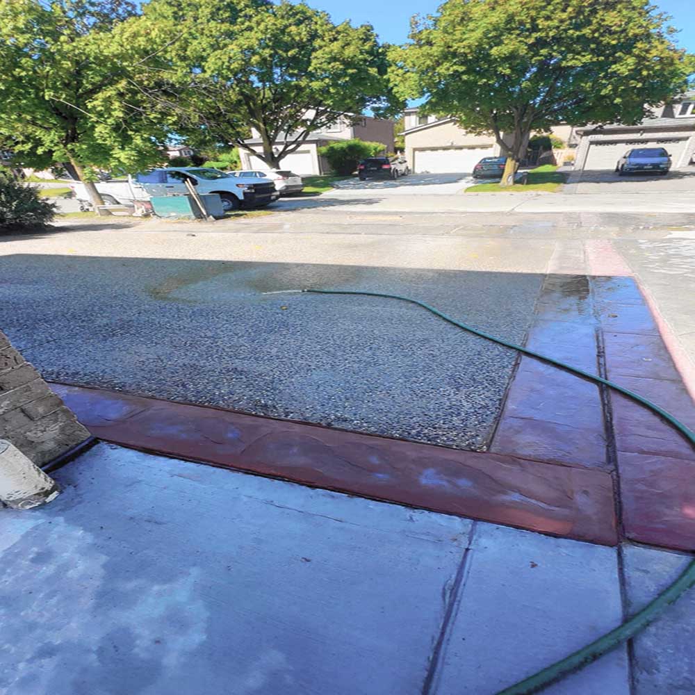 Exposed aggregate concrete porch with multi-tonal stone finish.