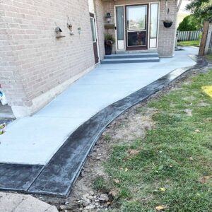 Professional plain concrete installation featuring custom color and a decorative border finish for a premium look.