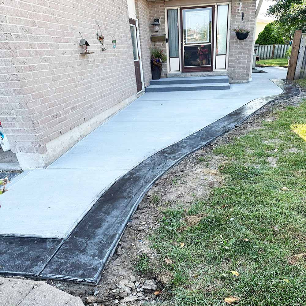 Professional plain concrete installation featuring custom color and a decorative border finish for a premium look.