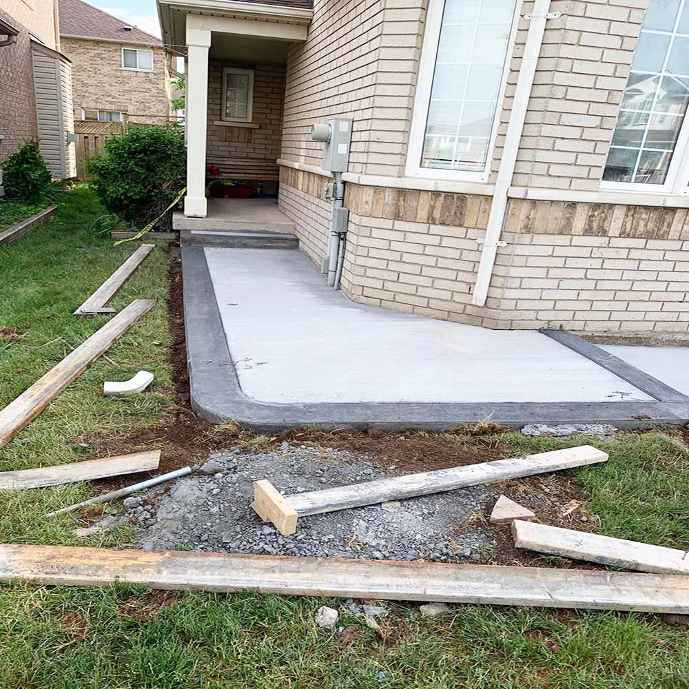 Professional plain concrete installation featuring custom color and a decorative border finish for a premium look.