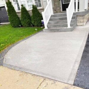 Professional plain concrete installation featuring custom color and a decorative border finish for a premium look.