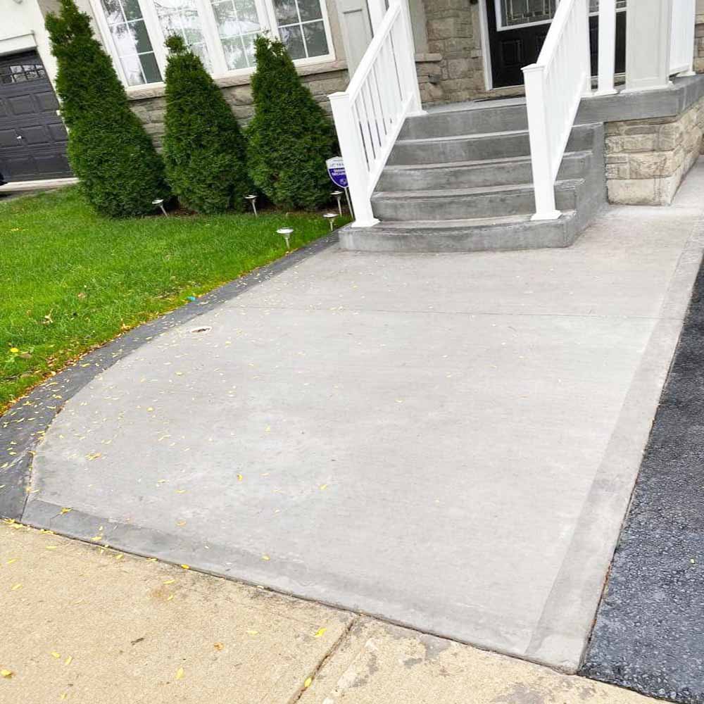 Professional plain concrete installation featuring custom color and a decorative border finish for a premium look.