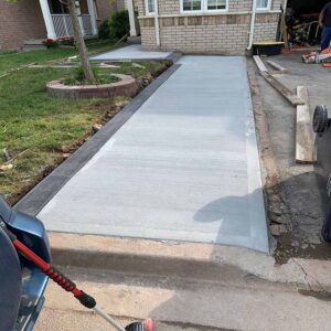 Professional plain concrete installation featuring custom color and a decorative border finish for a premium look.