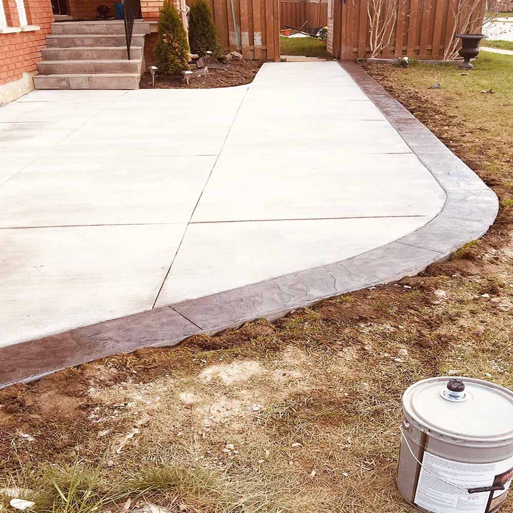 Professional plain concrete installation featuring custom color and a decorative border finish for a premium look.