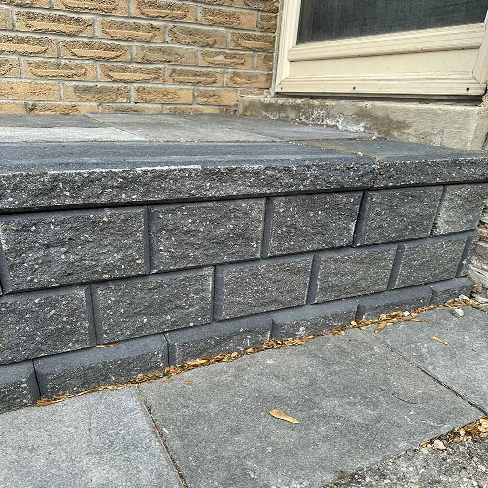 Close-up of natural stone blocks used for a durable garden flower bed.