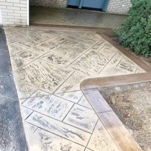 Custom stamped concrete driveway with elegant border detailing.