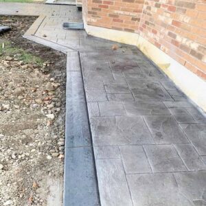 Modern stamped concrete pool deck with non-slip border.