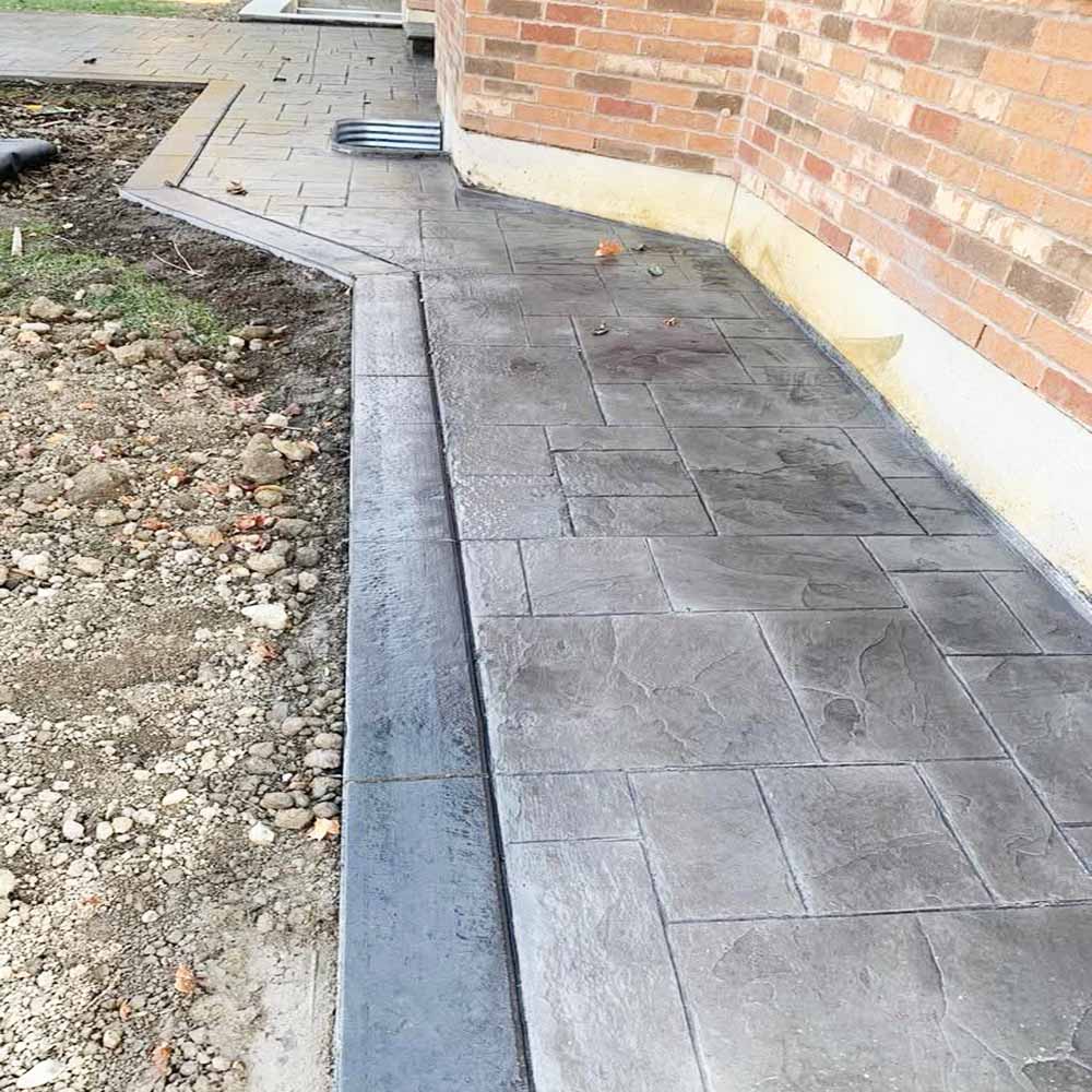 Modern stamped concrete pool deck with non-slip border.