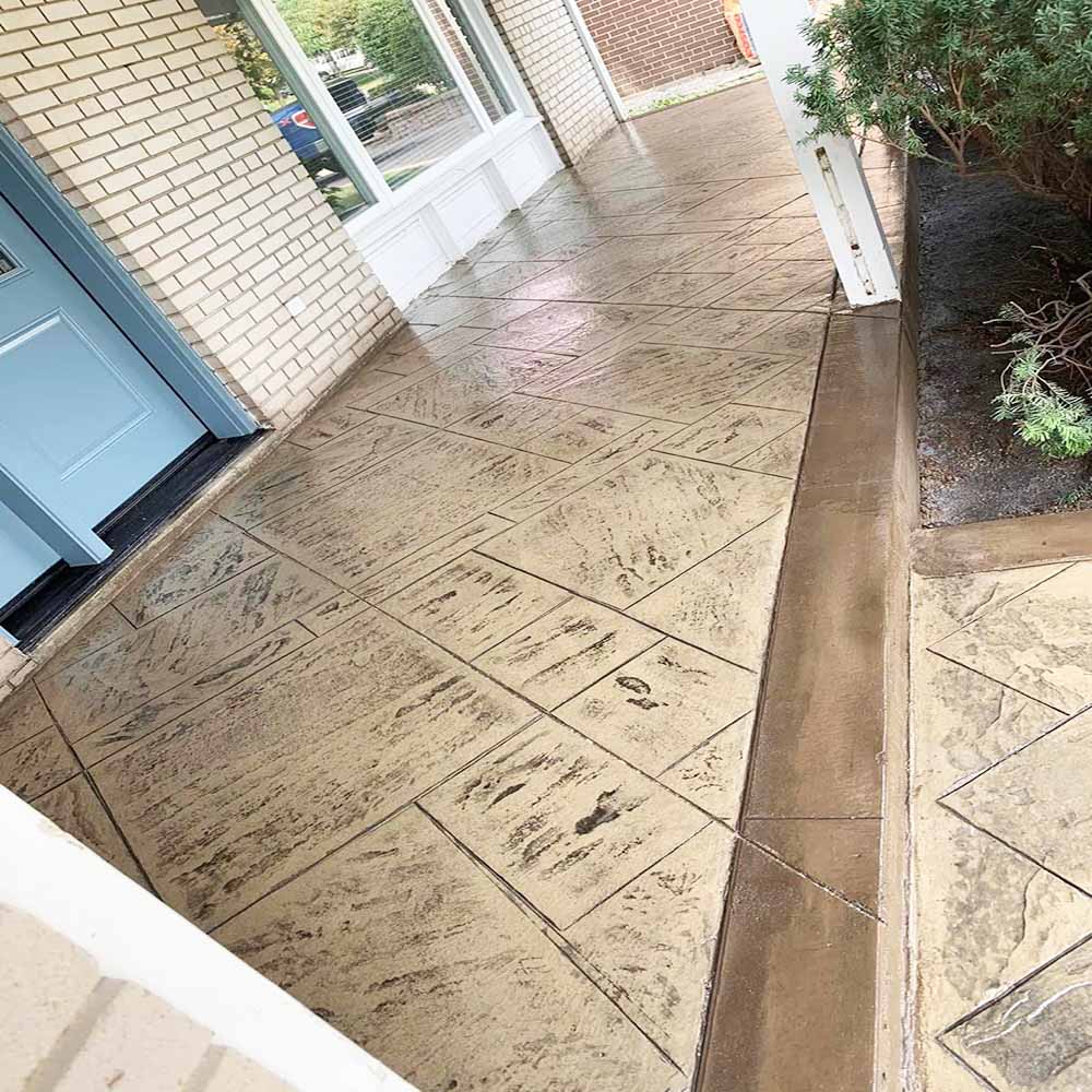 Large scale stamped concrete tiles with smooth borders.
