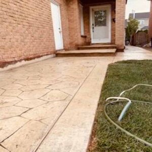 Wood-plank stamped concrete walkway installation.