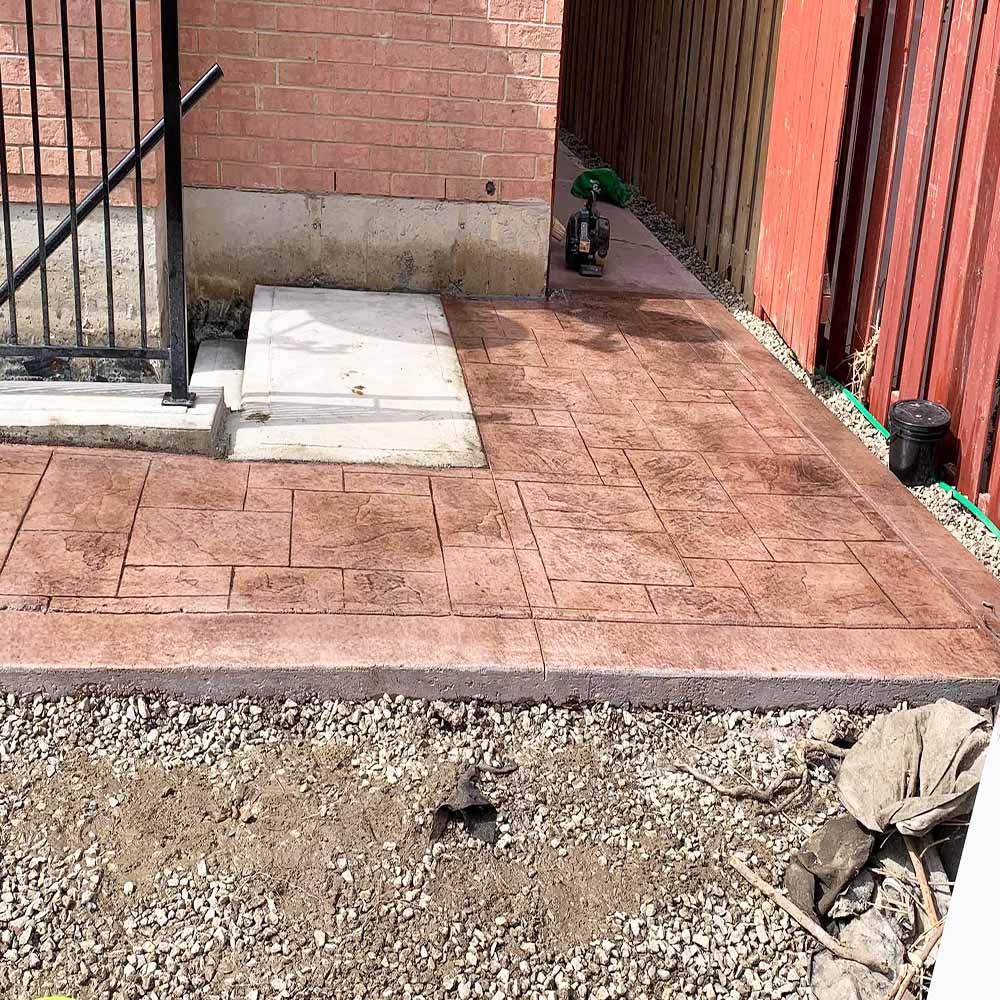 Textured stamped concrete walkway without border by Rhino The Renovators.