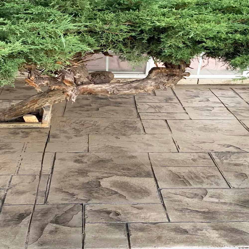 Modern stamped concrete driveway finish without border.