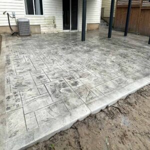 Large backyard stamped concrete pool deck. Large backyard Slate-patterned stamped concrete without border.
