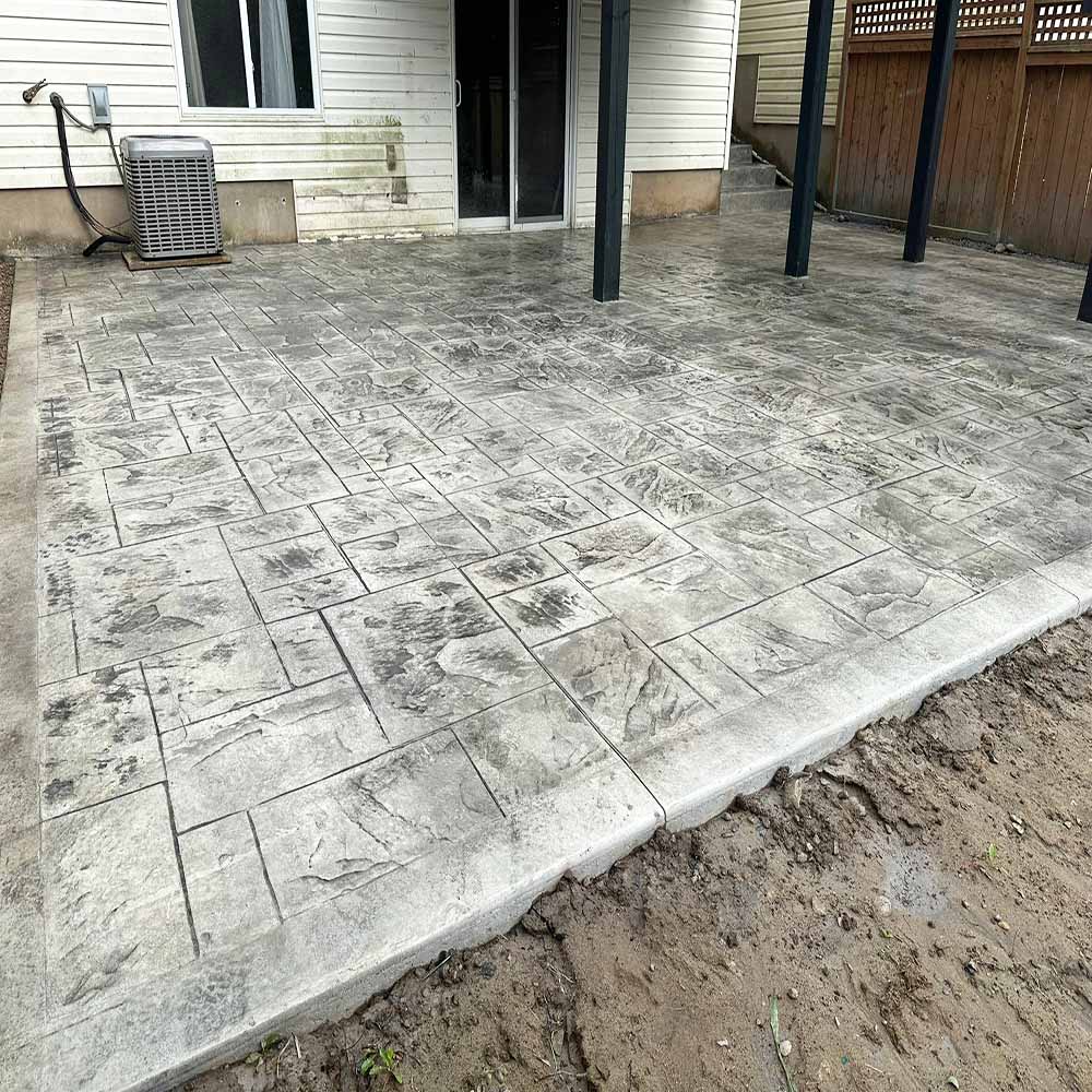 Large backyard stamped concrete pool deck. Large backyard Slate-patterned stamped concrete without border.