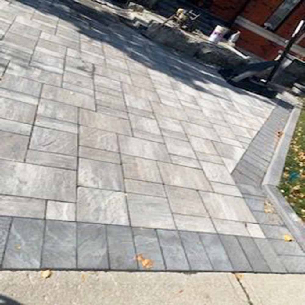 Interlocking stone retaining wall and patio combination.