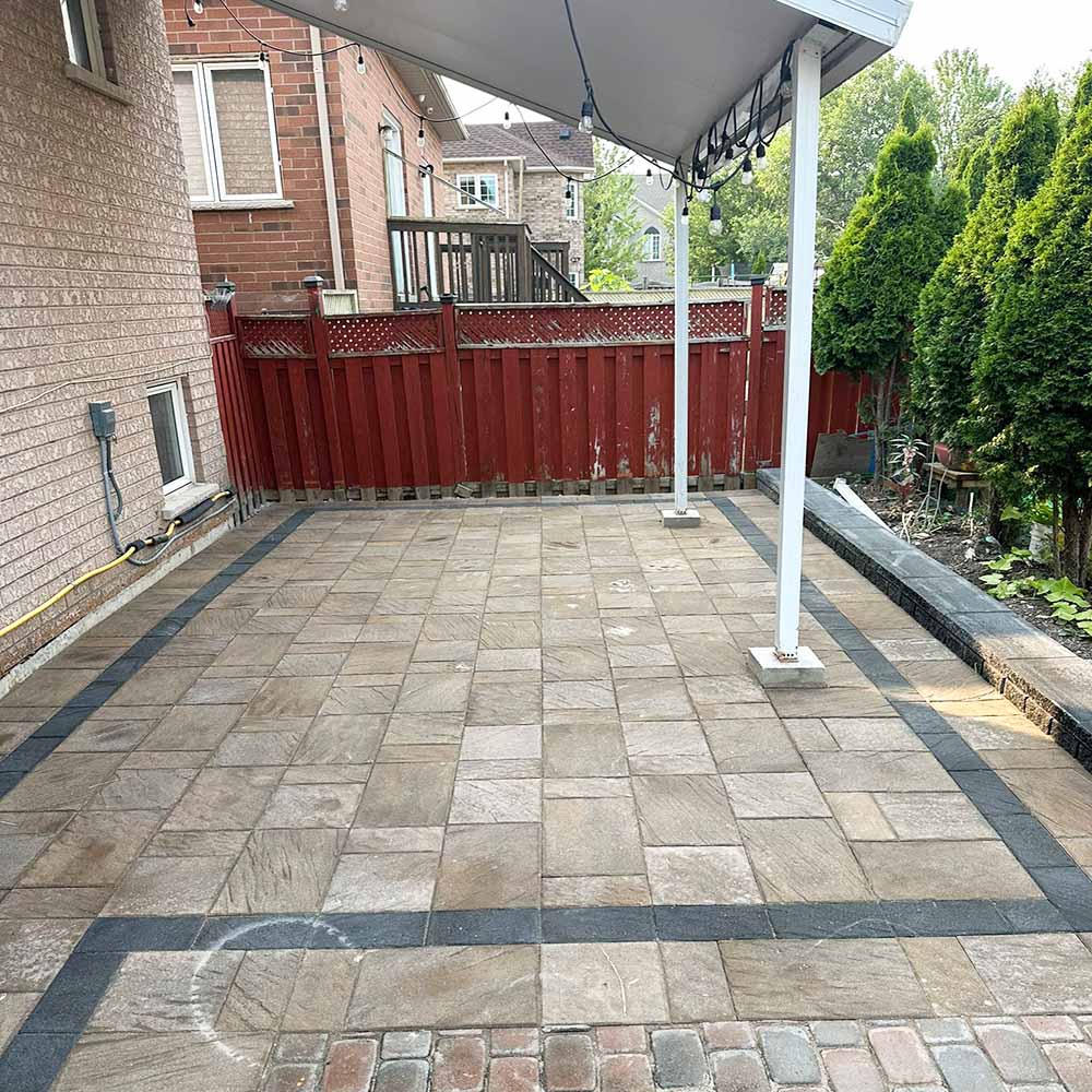 Interlocking stone walkway leading to a garden entrance.